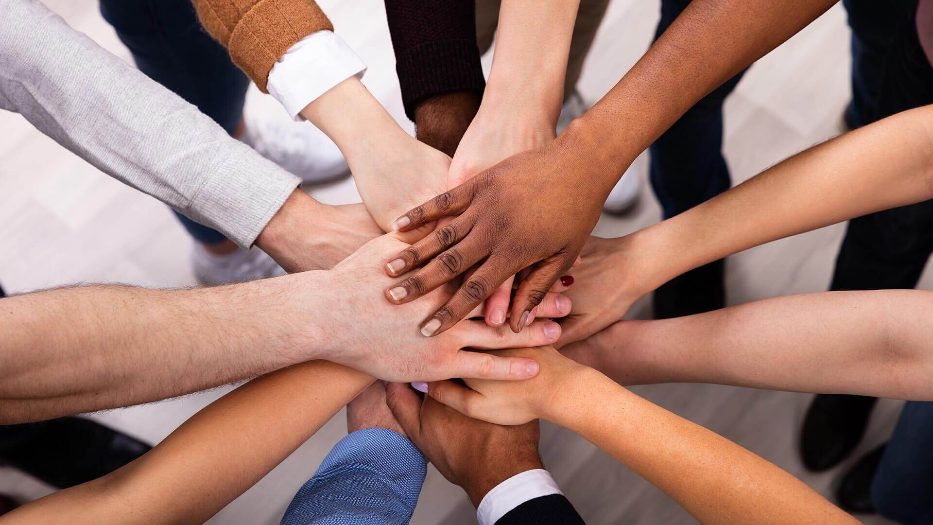 banner-diverse-people-stacking-hand-downsized